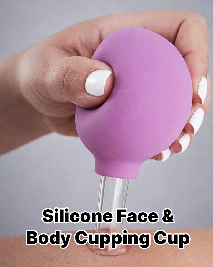 Hand squeezing a purple silicone cupping bulb