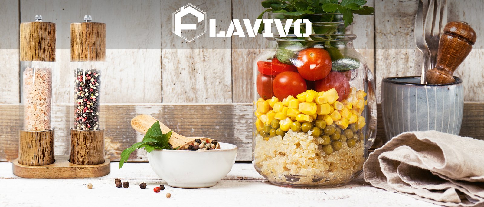 FLAVIVO brand banner with the grinder pair, a jar of vegetables, and the logo on a whitewashed wood background