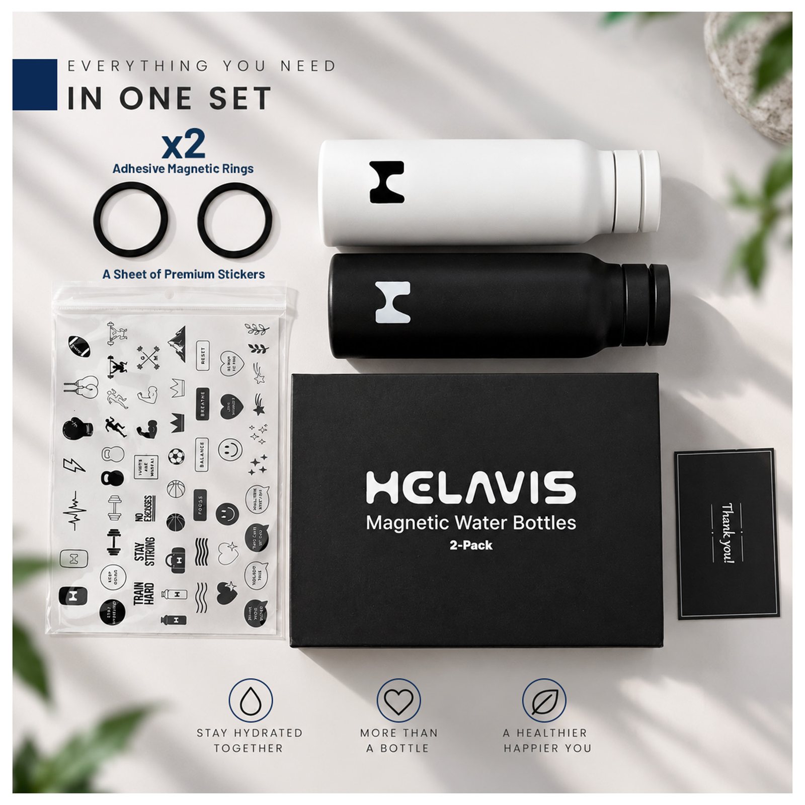 Flat lay of both bottles, two rings, sticker sheet, box, and thank-you card