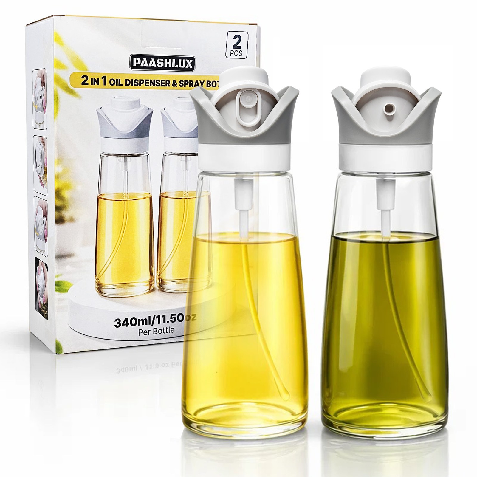 Two PAASHLUX glass oil bottles with grey 2-in-1 spray tops, one filled with olive oil and one with a lighter oil, in front of the product box on white