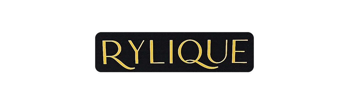 Rylique wordmark in gold on a black plate on white