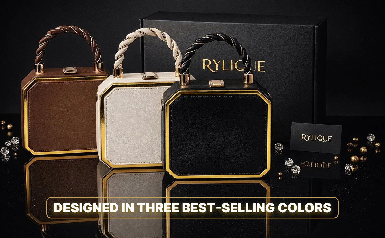 Brown, cream and black versions of the bag in front of the black gift box, with the line Designed in Three Best-Selling Colors