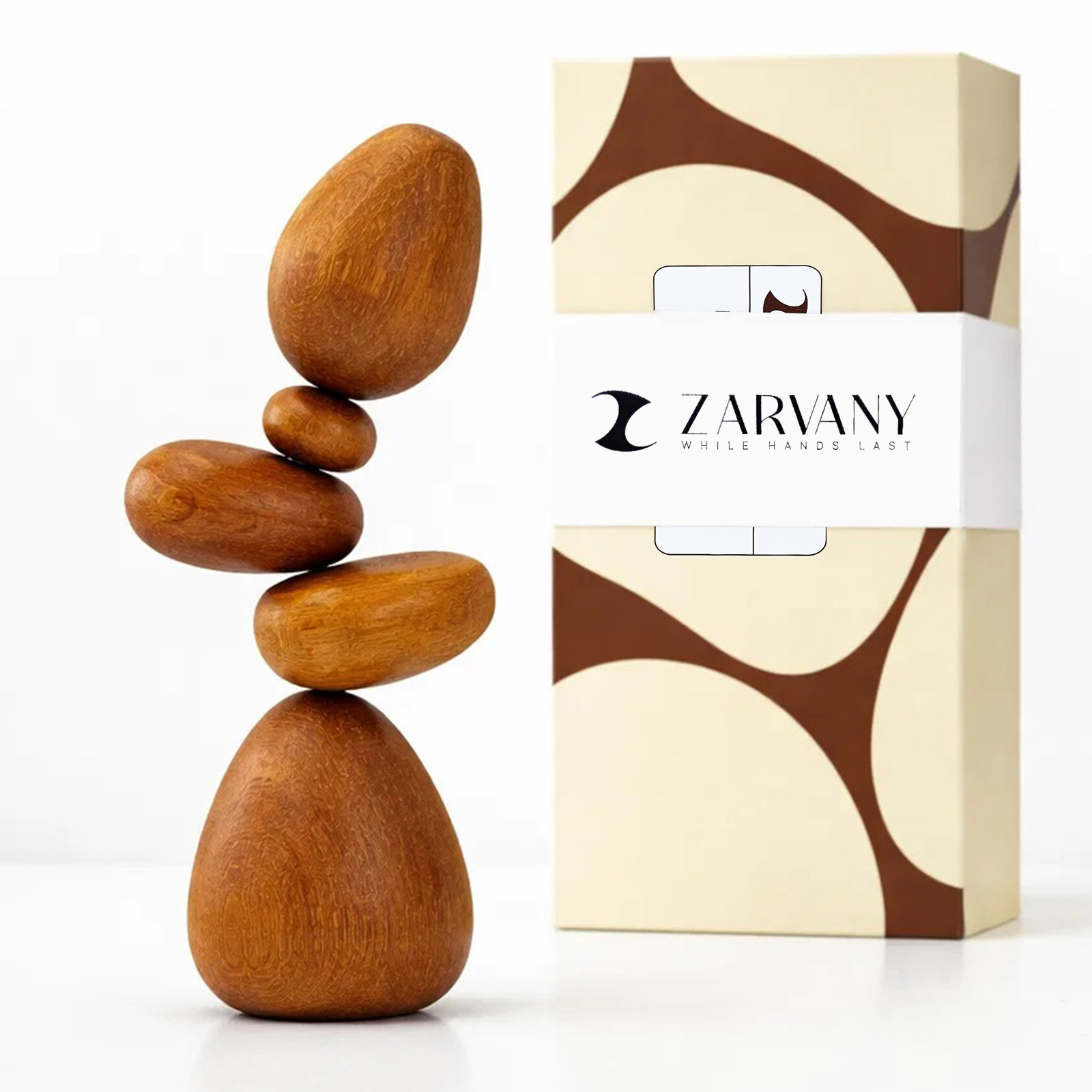 White background hero of five stacked wooden stones beside the cream and brown ZARVANY gift box