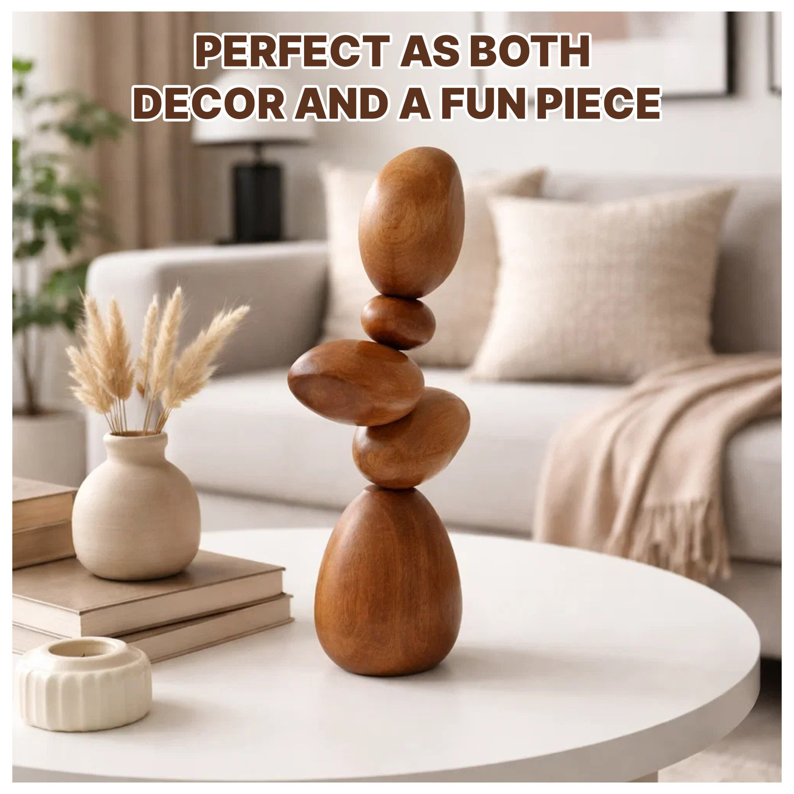 Living room scene with the stacked wooden stones on a coffee table beside a vase of dried grass