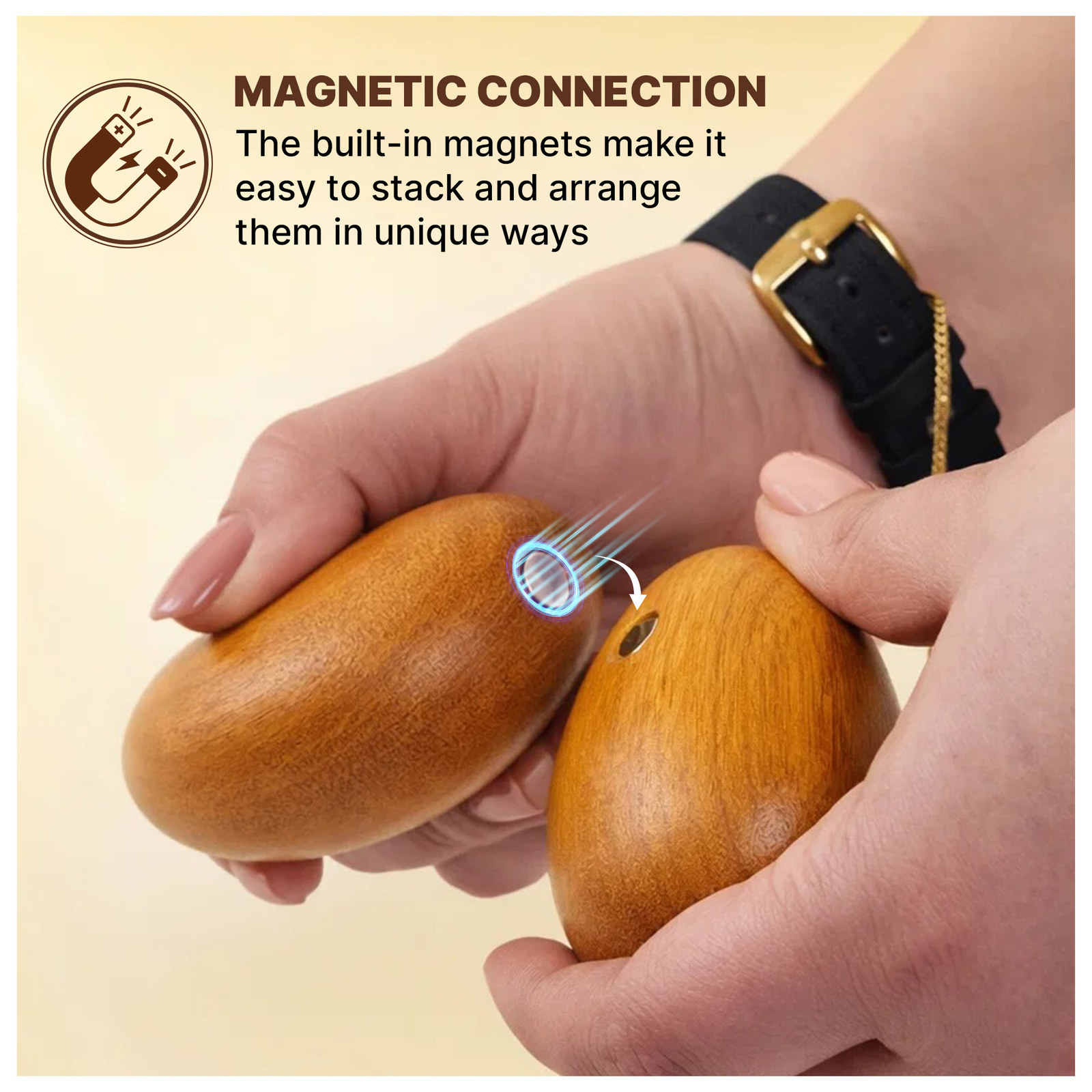 Two hands snapping two wooden stones together with a magnet icon