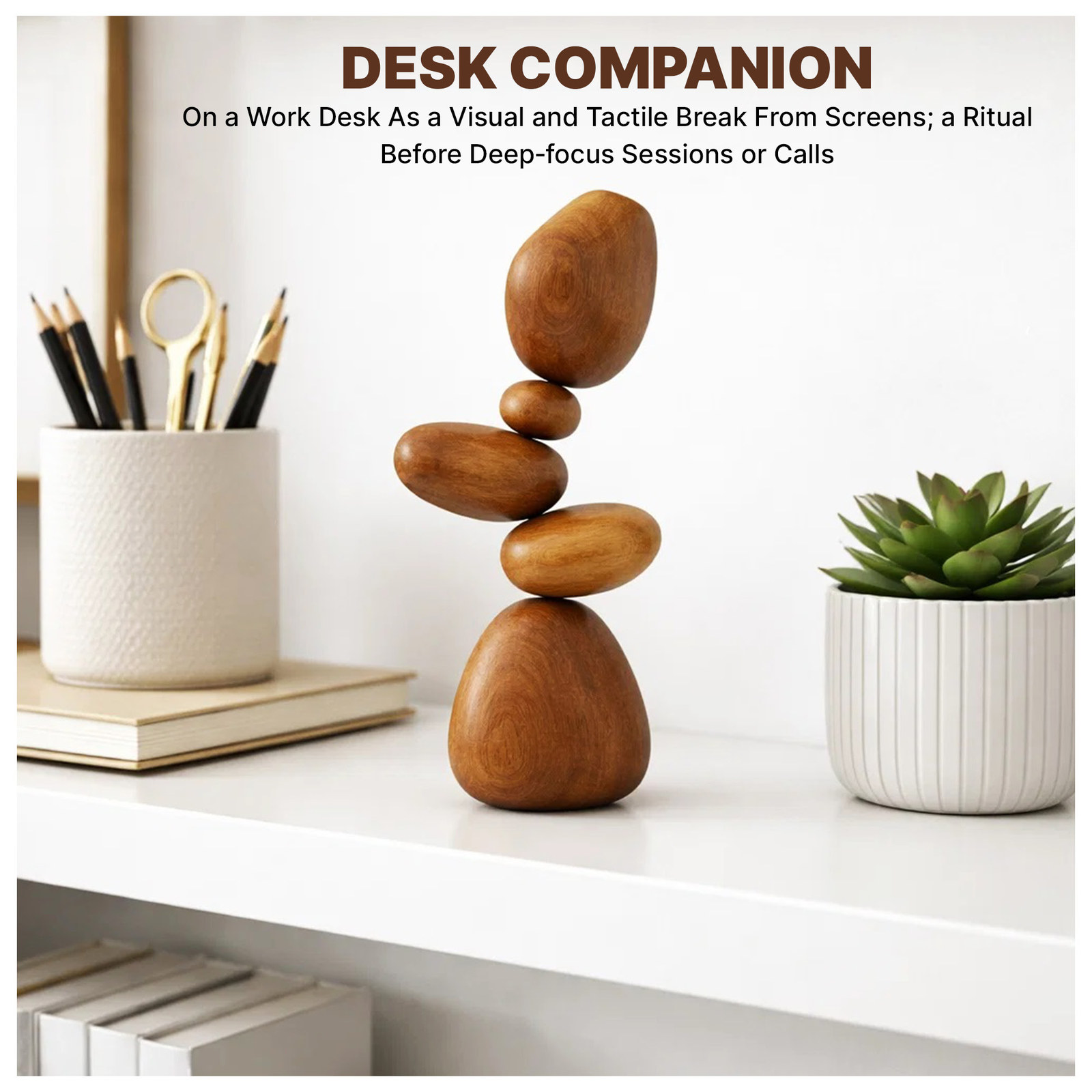Stacked wooden stones on a white shelf beside a pencil cup and a small succulent